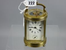 A late 19th/early 20th Century French brass and bevelled glass cylindrical cased carriage clock