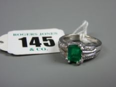 A diamond and possibly Columbian emerald set ring, emerald weight approximately 1.25 carats and