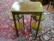 An Edwardian mahogany rectangular top table with circular folding cakestand ends, 72.5 cms high,
