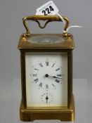 A late 19th Century brass carriage clock with presentation inscription in recognition of services as