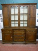 A good George III crossbanded oak dresser, the central six panel glazed doors flanked by twin