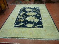 A K.K. Egyptian Super Ziegler wide bordered carpet with deep blue floral decorated central panel,