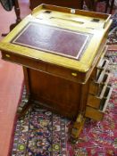A Victorian walnut Davenport with mahogany and boxwood string inlay, the galleried top with ink