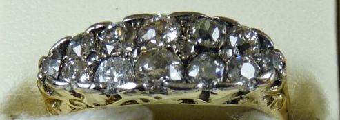 An eighteen carat gold diamond ring set with sixteen old cut diamonds in two rows, total weight 5