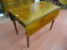 A 19th Century mahogany twin flap Pembroke table, single end drawer with turned wooden knobs and