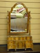 A late 19th Century Dutch oak and walnut dressing mirror, the plate in a shaped frame on turned