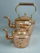 A large Georgian copper kettle with brass acorn knop and a small Victorian brass kettle with acorn
