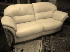 A modern quality cream leather two seater settee, 212 cms wide