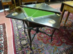 A late Victorian mahogany envelope card table having a gilt tooled edge baize interior, dished