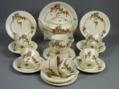 A twenty two piece Myott floral decorated teaset, two wirework trio stands and a plate stand