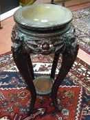 A carved Chinese hardwood two tier stand with dragon carved legs, 77 cms high