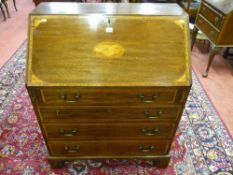 A circa 1900 mahogany and Sheraton inlaid fall front bureau having a well fitted interior of