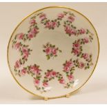 ATTRIBUTED TO NANTGARW PORCELAIN -  large saucer, finely painted with a pronged-garland of roses
