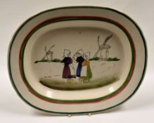 LLANELLY POTTERY - platter with red and green trim, the interior painted with a group of three Dutch