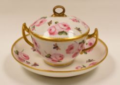 MANNER OF NANTGARW PORCELAIN - lidded and twin-handled chocolate cup and saucer with gilding and