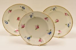 ATTRIBUTED TO SWANSEA PORCELAIN - a trio of circular plates, painted with individual flowers,