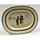 LLANELLY POTTERY - platter with red and green trim, the interior painted with a group of three Dutch