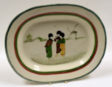 LLANELLY POTTERY - platter with red and green trim, the interior painted with a group of three Dutch