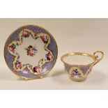 NANTGARW PORCELAIN - finely painted tea-cup and saucer, having gilded border with purple motif