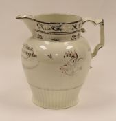 ATTRIBUTED TO SWANSEA POTTERY - silver gilt decorated jug with flowers to the body and inscription