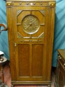 A good 20th Century carved oak hall robe, the single door with inset carved roundel, further