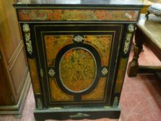 An ebonized and red Boulle single door side cabinet circa 1870 with ormolu mounts and velvet lined