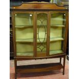 An Edwardian crossbanded mahogany two door display cabinet with centre glazed panel and shaped
