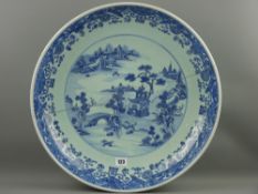 A large 19th Century Chinese deep dish charger, blue and white scroll pattern decoration with