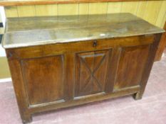 An 18th Century oak coffer having a two plank moulded edge top and three inset raised chamfered