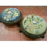 A pair of Victorian carved walnut circular footstools with tapestry tops, leaf and floral deep