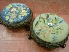 A pair of Victorian carved walnut circular footstools with tapestry tops, leaf and floral deep
