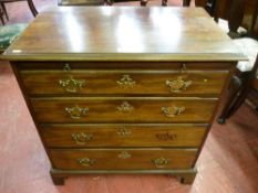 A 19th Century mahogany bachelor's chest of four graduating oak lined drawers with brushing slide,