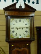 An early 19th Century inlaid mahogany longcase clock, the hood with broken architectural pediment,