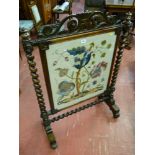 A Victorian mahogany barley twist firescreen with embroidered panel of flowers and animals, open