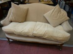 An early 20th Century walnut framed upholstered parlour settee with curved back and shaped arms,