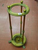 A Victorian circular brass stickstand on knuckled column supports with brass knob caps and hairy paw