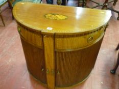 An inlaid mahogany Sheraton style demi-lune side cabinet, the top with stained shell inlay and