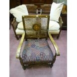 An oak upholstered armchair with carved front rail and Bergere back and a pair of armchairs with