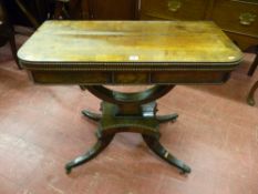 A William IV rosewood foldover card table on an open curved support, short pedestal and platform