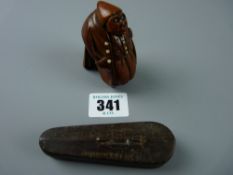A finely carved early 19th Century coquilla nut snuff box in the form of a hunched portly gent in