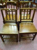 A set of four antique oak farmhouse chairs with reeded spindle backs