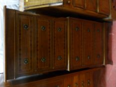 A reproduction crossbanded mahogany one piece chest on chest having six drawers with brass ring