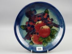 A 26 cms diameter Moorcroft Finches plate with tube lined bird and fruit decoration on a deep blue