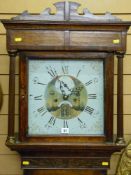 A circa 1800 oak longcase clock with shaped pediment and reeded pillars flanking a single glazed