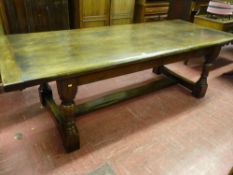 A good sized reproduction oak refectory table on turned block supports with substantial stretchers