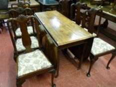 A 19th Century mahogany dining table having large twin flap leaves and central gate supports on