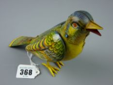 Toys - a German made tinplate wind-up bird, green and yellow coloured and marked 'Ges. Gesch', 19