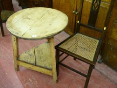 A stripped antique pine cricket table on chamfered legs with triangular under tier, 65.5 cms high,