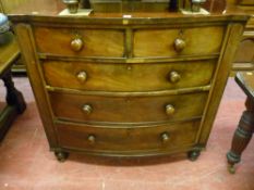 A Victorian mahogany bow front chest of two short over three long drawers with turned wooden handles