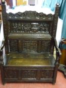 A good 17th Century style carved oak box seat hall bench, profusely carved patterns and mottos